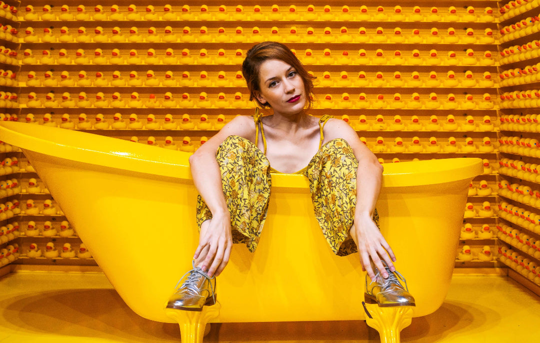 Woman sitting on bath full of hot water system hot water