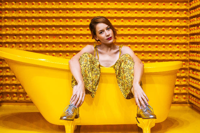 Woman sitting on bath full of hot water system hot water