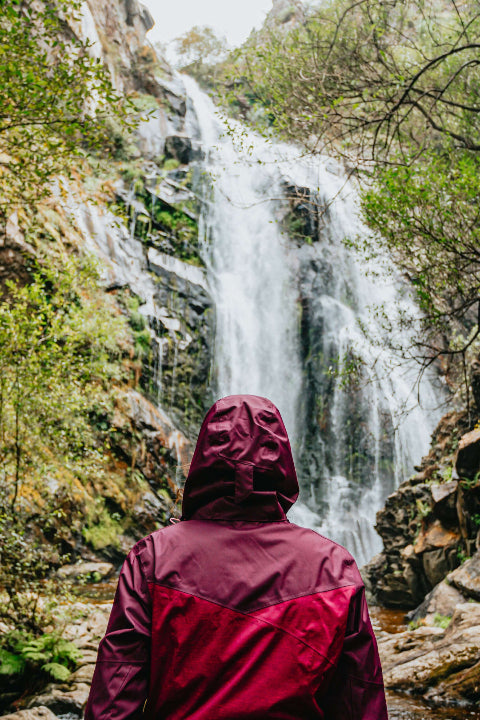 Man tanding in front of hot water fall